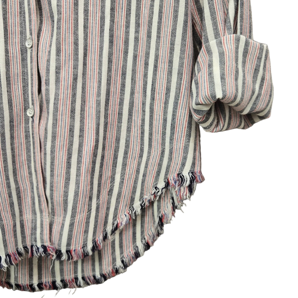 Close-up of a striped button-up shirt with rolled sleeves and a frayed hem, laid flat on a textured gray fabric background.