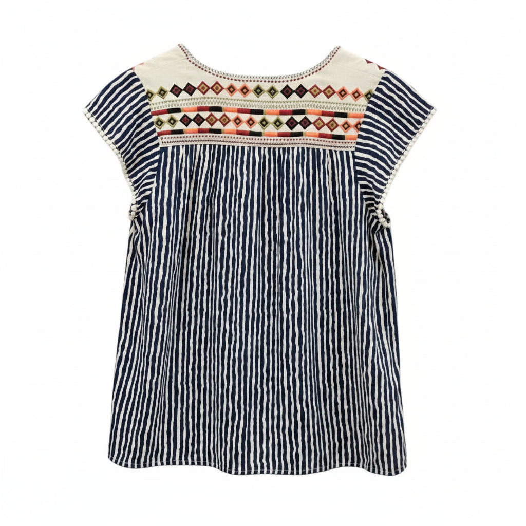A short-sleeve bohemian-style top with vertical navy and white stripes, featuring a colorful geometric embroidered neckline. 