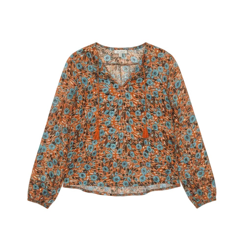 A women's long-sleeve blouse with an orange, blue, and white floral pattern.