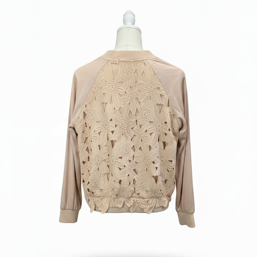 A beige long-sleeve top with a floral lace overlay on the front.