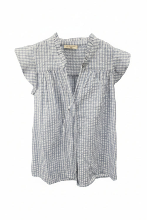 A light blue and white gingham short-sleeve blouse.